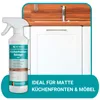 A spray bottle of kitchen cleaner is shown in front of kitchen cabinets and a wooden countertop with a sink. Produktbild-Vorschau