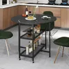 A round dining table with shelves in a kitchen setting, with chairs around it. Anteprima dell’immagine prodotto