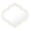 A decorative quatrefoil mirror with a gold trim, isolated on a white background. Produktbild-Vorschau