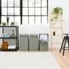A bathroom or laundry room setting with laundry baskets, towels, and a ladder shelf. Produktbild-Vorschau