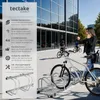 A woman is talking on her phone next to a bicycle rack outside a modern building. Náhled obrázku produktu