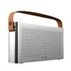 A silver portable speaker with a brown leather handle, shown against a white background. Produktbild-Vorschau