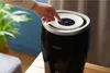 A person's hand is shown adjusting the settings on a Philips humidifier. Produktbild-Vorschau