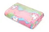 A folded blanket with a unicorn pattern on a white background. Anteprima dell’immagine prodotto