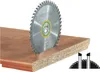 A circular saw blade is shown partially embedded in a piece of wood. Podgląd zdjęcia produktu