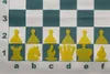A chess set with yellow pieces arranged on a green and white checkered board. Voir les images du produit
