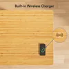 A close-up overhead view of a wooden desk with a smartphone charging wirelessly. Produktbild-Vorschau