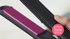 A close-up shot of a hair straightener, showing the heated plates and a hand holding the device. Voir les images du produit
