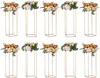 A collection of gold geometric stands topped with floral arrangements.