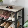 A close-up view of a multi-tiered shoe rack filled with various types of women's shoes, with a wallet and a braided accessory on the top shelf. Náhled obrázku produktu