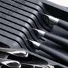 A close-up view of a black cutlery organizer with slots for knives and spoons. Náhled obrázku produktu