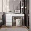 A modern bedroom with a white vanity desk and stool, next to a bed. Produktbild-Vorschau