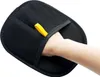 A hand is shown inserting into a black pet grooming glove with a yellow loop. Produktbild-Vorschau