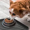 A dog eating from a food bowl placed on a mat. Anteprima dell’immagine prodotto