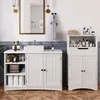 A white bathroom vanity and storage cabinet are shown in a well-lit bathroom. Produktbild-Vorschau