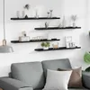 A living room scene with a sofa and shelves mounted on the wall above it. Podgląd zdjęcia produktu