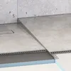 A close-up view of a shower drain system, showing the profile and tiling. Produktbild-Vorschau