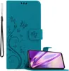 A teal flip phone case with a floral and butterfly design, shown open with a smartphone inside. Anteprima dell’immagine prodotto