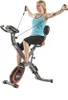 A woman is using a folding exercise bike with resistance bands. Produktbild-Vorschau