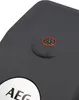 A close-up view of a dark gray surface with a small compass and a circular silver emblem with the letters 'AEG' on it. Podgląd zdjęcia produktu