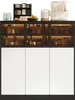 A modern sideboard cabinet with glass doors displaying kitchenware and appliances. Produktbild-Vorschau