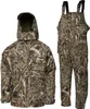 A camouflage jacket and bib overalls are displayed against a white background. Produktbild-Vorschau