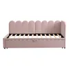 A pink velvet daybed with a scalloped headboard and a pull-out drawer underneath, shown against a white background. Podgląd zdjęcia produktu