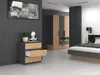 A modern bedroom with a dresser, wardrobe, and bed. Anteprima dell’immagine prodotto