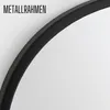 A close-up view of a black metal frame of a round mirror against a white background. Produktbild-Vorschau