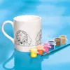 A white mug with a Paw Patrol design and a set of paints and a brush. Produktbild-Vorschau