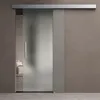 A frosted glass sliding door with a silver handle, mounted on a wall. Produktbild-Vorschau