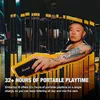 A person is holding a Marshall speaker in a stylized, abstract environment with yellow and black elements resembling taxi partitions. Produktbild-Vorschau