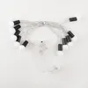 A string of battery-powered LED lights with white bulbs and black caps, laid out on a white background. Náhled obrázku produktu