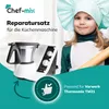 A young girl dressed as a chef holds a rolling pin next to a kitchen machine. Produktbild-Vorschau