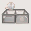 A baby playing inside a playpen. Anteprima dell’immagine prodotto