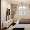 A bedroom with a TV stand and a TV. Podgląd zdjęcia produktu