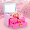A pink makeup case with a mirror and drawers, set against a soft pink, blurred background. Produktbild-Vorschau