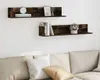 Two wall shelves mounted on a white wall above a sofa. Náhled obrázku produktu