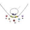 A jewelry set with a necklace and bracelet, along with loose beads and charms, laid out on a white background. Produktbild-Vorschau