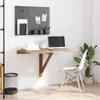 A wall-mounted folding desk with a laptop, books, and office supplies. Produktbild-Vorschau