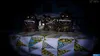Three nightmare animatronic teddy bears sitting on a bed with a patterned quilt. Náhled obrázku produktu
