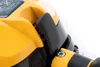 Close-up of a yellow and black power tool handle with a black lever. Produktbild-Vorschau