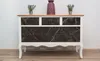 A dresser with marble-patterned drawers against a white wall. Náhled obrázku produktu