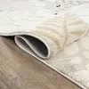 A close-up view of a rolled-up rug on a wooden floor. Náhled obrázku produktu