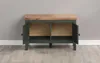 A dark green cabinet with a wooden top, set against a light gray wall and a wooden floor. The cabinet doors are open, revealing two compartments inside. Anteprima dell’immagine prodotto