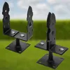 Two black metal post brackets are shown in a close-up shot against a blurred background of green grass and a blue sky. Produktbild-Vorschau