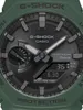 A close-up view of a green G-Shock watch face, showing the analog hands, digital display, and various markings. Produktbild-Vorschau