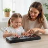 A mother and daughter are playing a keyboard together. Náhled obrázku produktu