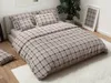 A neatly made bed with plaid bedding in a bedroom setting. Náhľad obrázku produktu