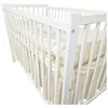 A white wooden crib with bedding. Náhled obrázku produktu